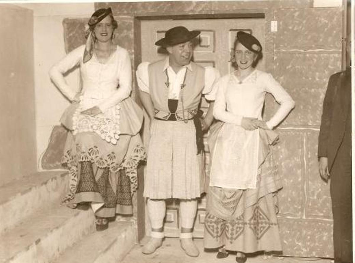 Foto de Néstor con dos modelos llevando sus trajes.