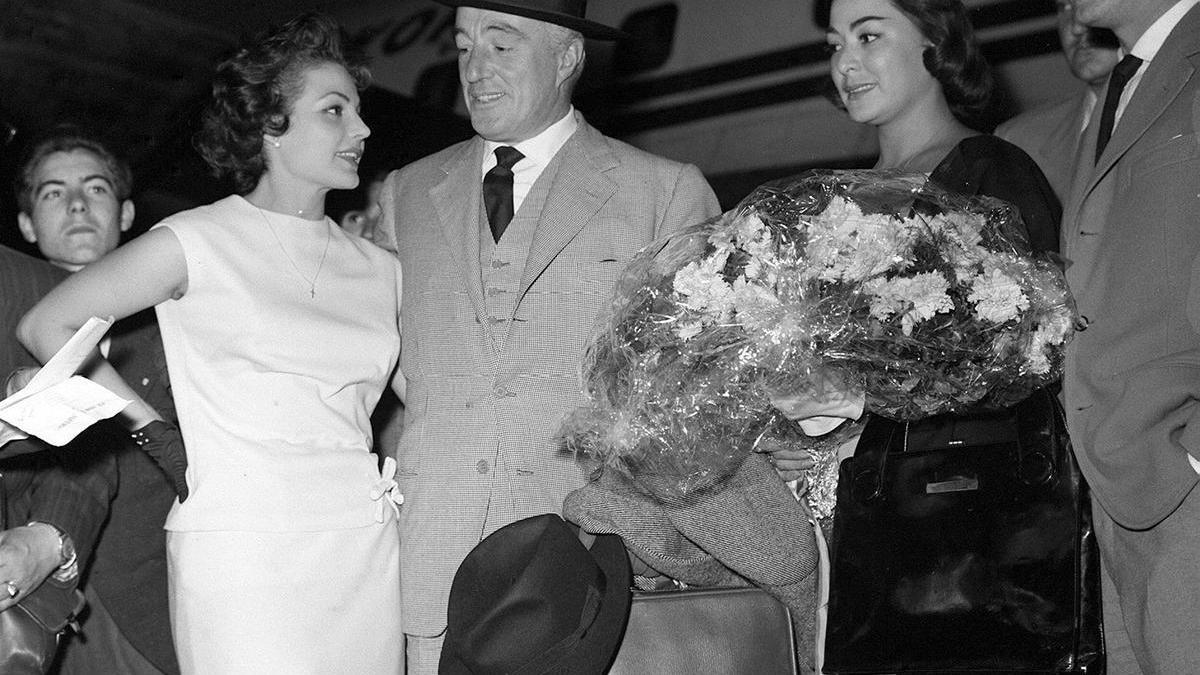 El actor Vittorio de Sica (c) a su llegada a Madrid, donde es recibido por los actores, Carmen Sevilla, Columba Dominguez y Vicente Parra (de dcha. a izq.). Todos ellos intervendrán en la co-producción italo-española &#039;Pan, amor y Andalucía&#039;, en 1958.