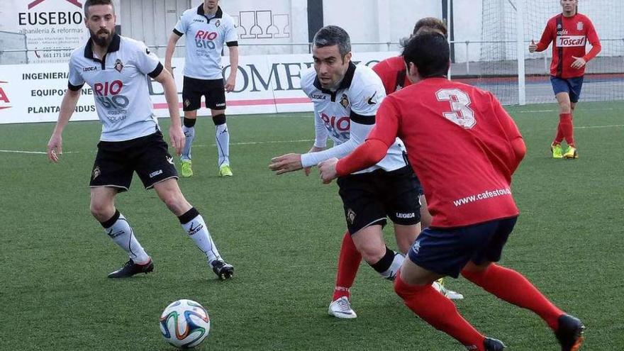 Invernón intenta irse de dos jugadores del Praviano en el duelo de la pasada temporada.