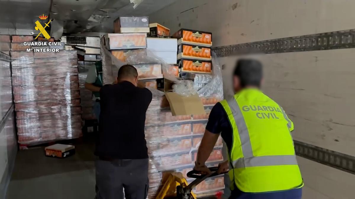 Agentes de la Guardia Civil con el cargamento de drogas, herramientas y otros útiles intervenidos.