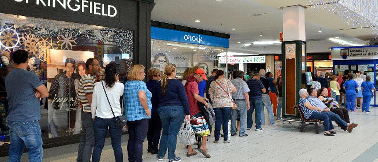 Los clientes de La Brujita hacen cola para comprar su décimo de Lotería de Navidad en la administración número uno en ventas de Canarias, en Alcampo.