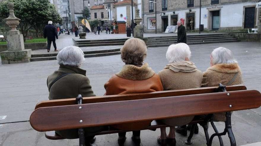 Un grupo de jubiladas, en un banco de A Ferrería.