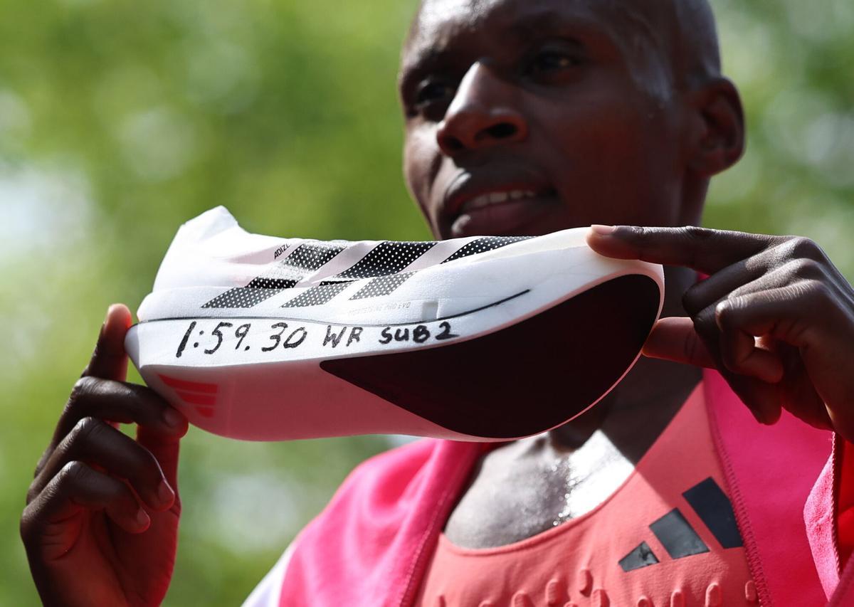 El keniano Sabastian Sawe posa con su zapatilla tras ganar el maratón de Londres con un récord del mundo
