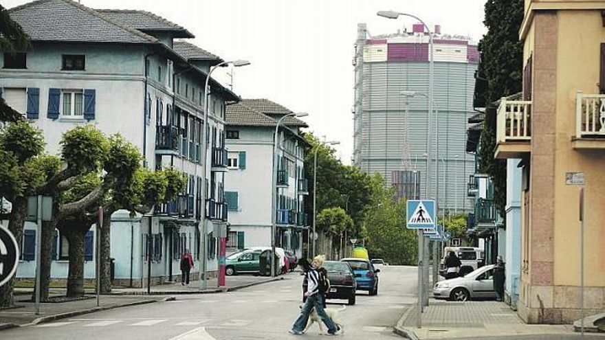 Casas del barrio de Llaranes; al fondo, uno de los gasómetros de Arcelor-Mittal.