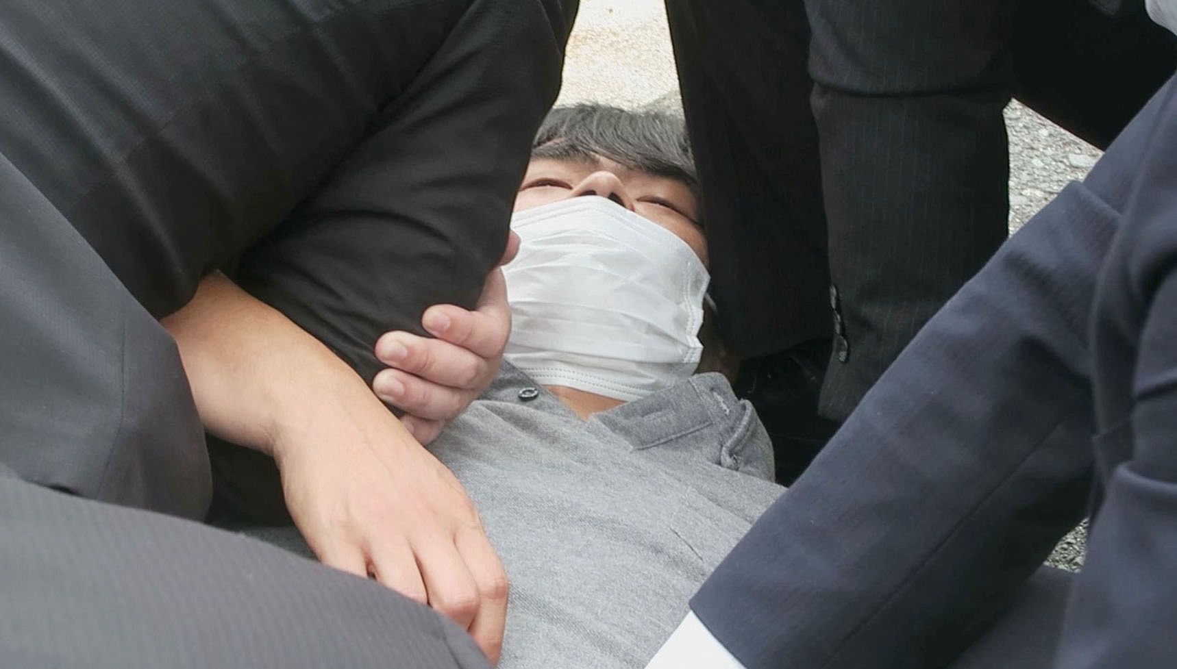 A video screengrab shows a man, believed to have shot former Japanese Prime Minister Shinzo Abe, being restrained by police officers in Nara