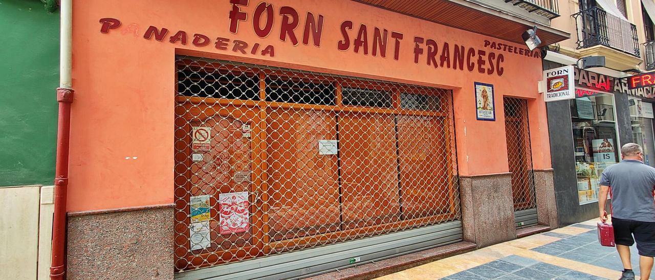 Fachada del céntrico Forn de Sant Francesc, donde un cartel confirma el cierre del establecimiento por cese de negocio. | JL. LLAGÜES