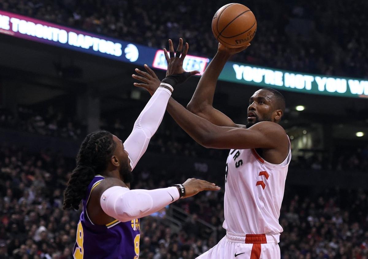 Jan 1, 2019; Toronto, Ontario, CAN;  Toronto Raptors center Serge Ibaka (9) shoots for a basket over Utah Jazz forward Jae Crowder (99) in the first half at Scotiabank Arena. Mandatory Credit: Dan Hamilton-USA TODAY Sports