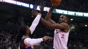 Jan 1, 2019; Toronto, Ontario, CAN;  Toronto Raptors center Serge Ibaka (9) shoots for a basket over Utah Jazz forward Jae Crowder (99) in the first half at Scotiabank Arena. Mandatory Credit: Dan Hamilton-USA TODAY Sports