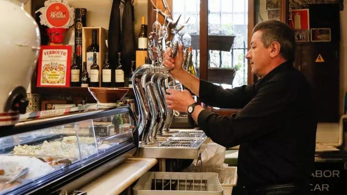 Un camarero sirve una cerveza.