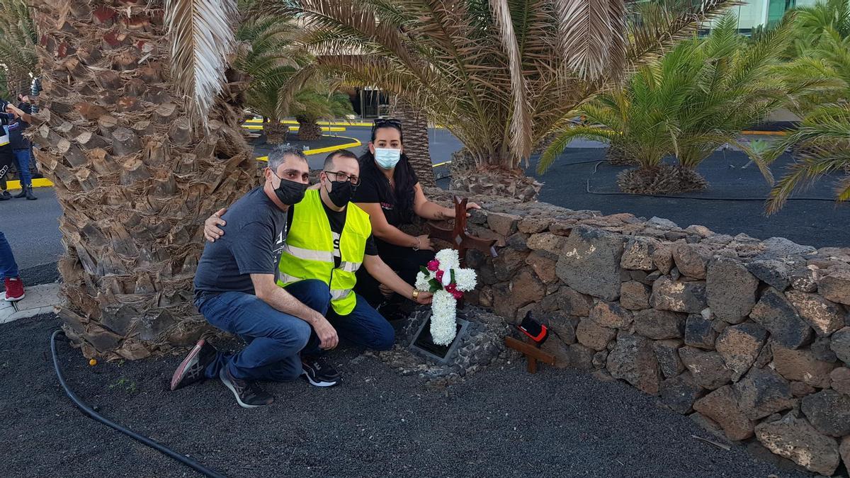 De izquierda a derecha, Juan Francisco Padilla, José Manuel Rodríguez y Brenda Pérez, amigos de Arturo Rivas, junto al pequeño monumento en un su memoria.