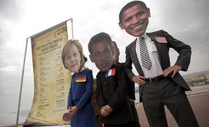 Manifestants amb caretes d’Angela Merkel, Nicolás Sarkozy i Barack Obama, en una manifestació contra el G-20 a Niça.