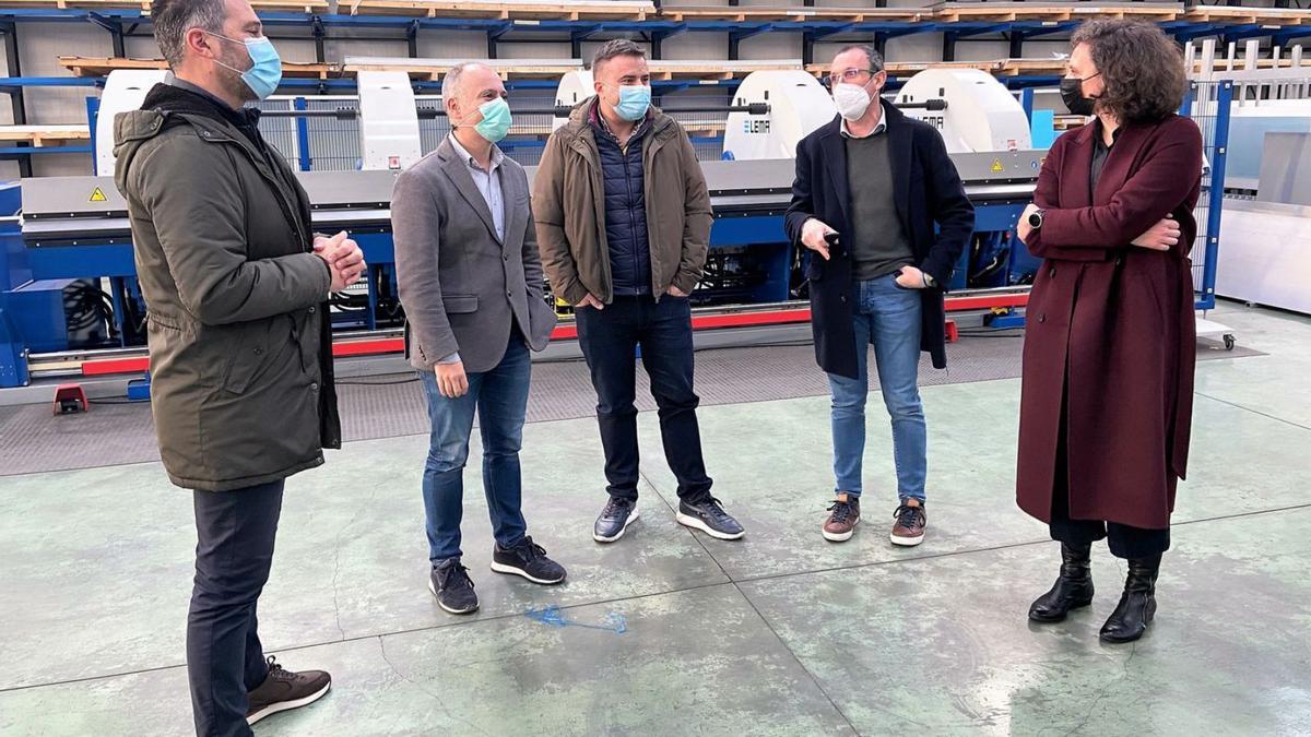 David Regades (2º izq.) y María Ferreirós en la planta de producción de Lema, en Valga. 