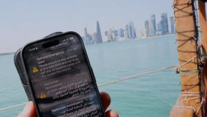 La pantalla de un móvil mostrando alertas del Ministerio del Interior de Qatar en la que aconseja a su población permanecer en sus casas ante el aumento de la tensión en la región.