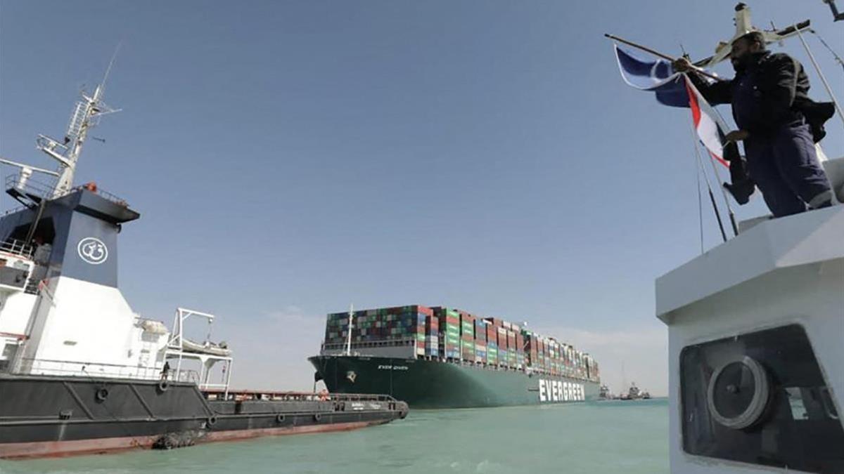 A picture released by Egypt s Suez Canal Authority on March 29  2021  shows a tugboat pulling the Panama-flagged MV  Ever Given  container ship after it was fully dislodged from the banks of the Suez  - The ship was refloated and the Suez Canal reopened  sparking relief almost a week after the huge container ship got stuck and blocked a major artery for global trade  Salvage crews have been working around the clock ever since the accident which has been blamed on high winds and poor visibility during a sandstorm  (Photo by -   SUEZ CANAL AUTHORITY   AFP)