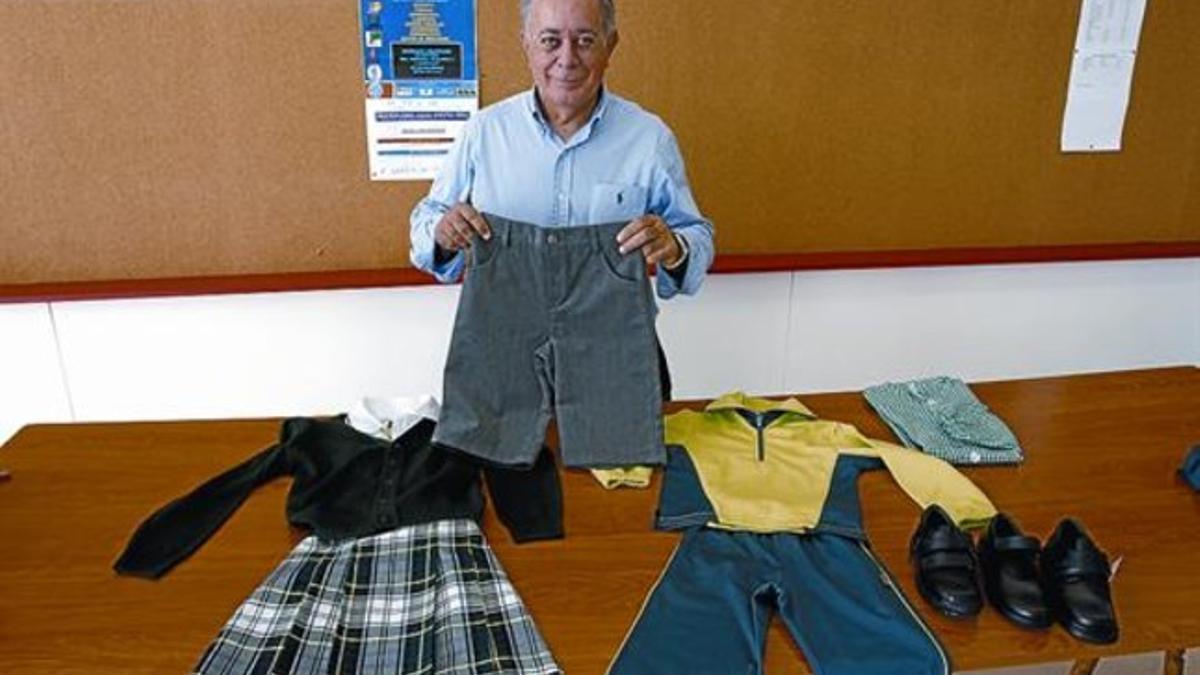 El director del colegio Màrius Torres, Jorge León, muestra los uniformes para el curso que viene, ayer.