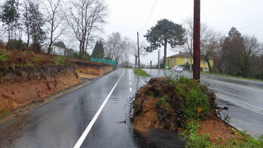 Poste de Telefónica rodeado de raíces, hierba y tierra, en medio del carril bici en la subida hacia Arillo.