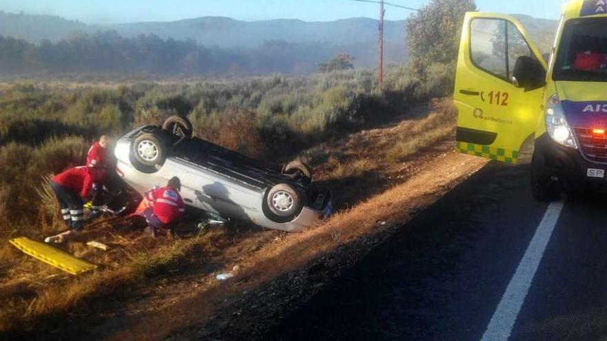 Sanitarios del 112 atienden a la persona accidentada ayer en la N-525 a su paso por San Miguel.