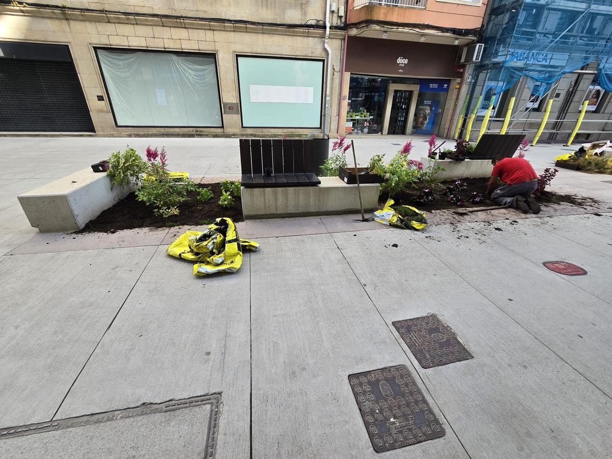 Los operarios municipales se encargan esta mañana de recuperar los deteriorados jardines de la peatonalizada calle de Arzobispo Lago, en Vilagarcía.