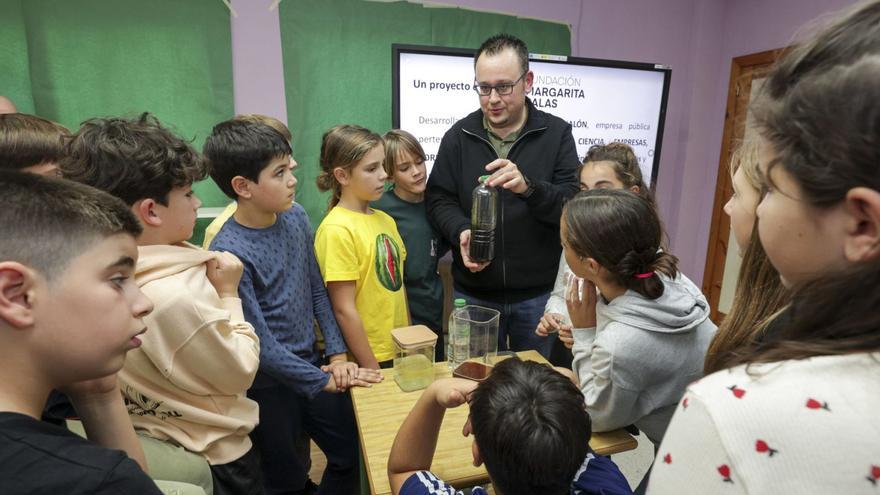 David Fernández realiza un experimento ante la mirada atenta de los alumnos en el colegio Príncipe de Asturias.