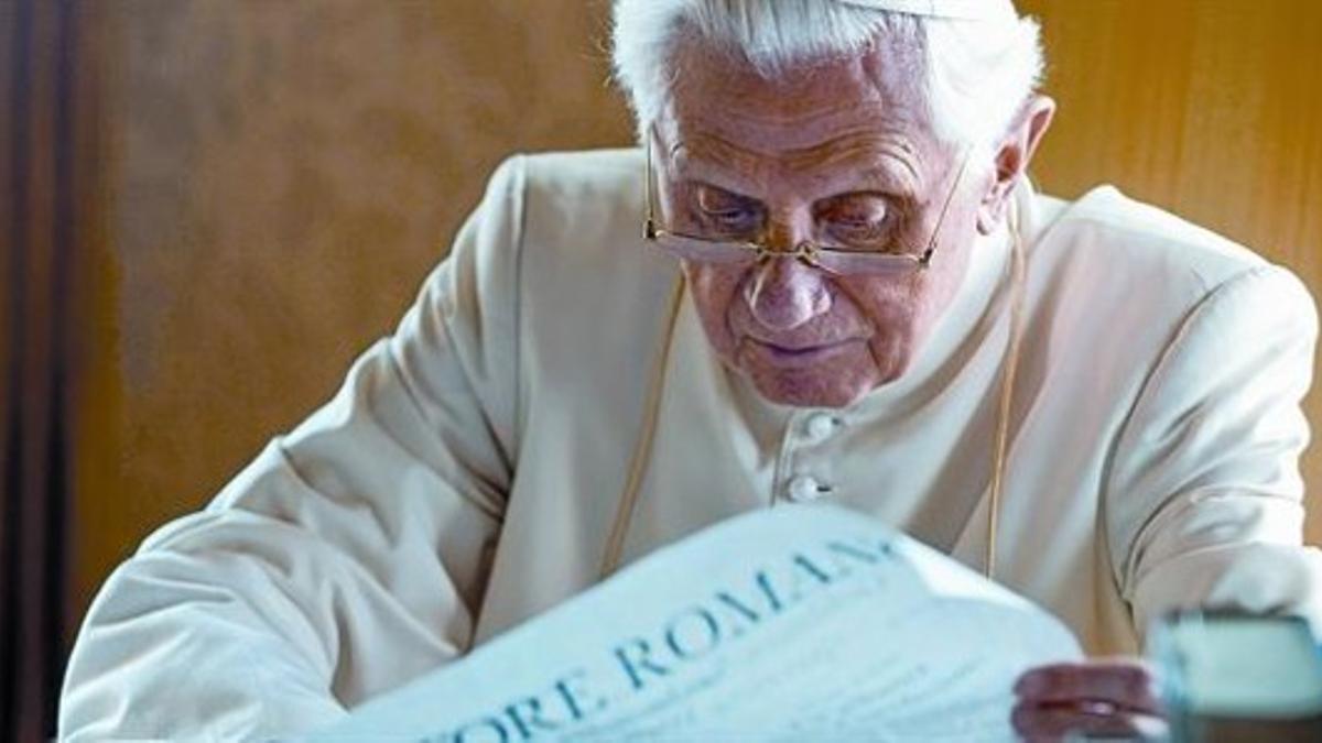 El papa Benedicto XVI lee atento un diario en su despacho de Castel Gandolfo.