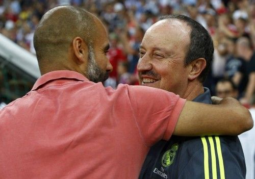 Bayern Munich's coach Guardiola speaks to Real Madrid's coach Benitez before their pre-season Audi Cup tournament final soccer match in Munich