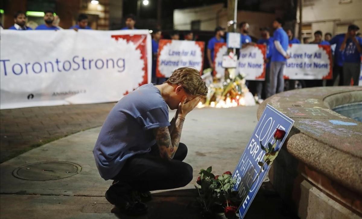 undefined44428810 a man reacts at a vigil in remembrance of the victims of a s180725131754