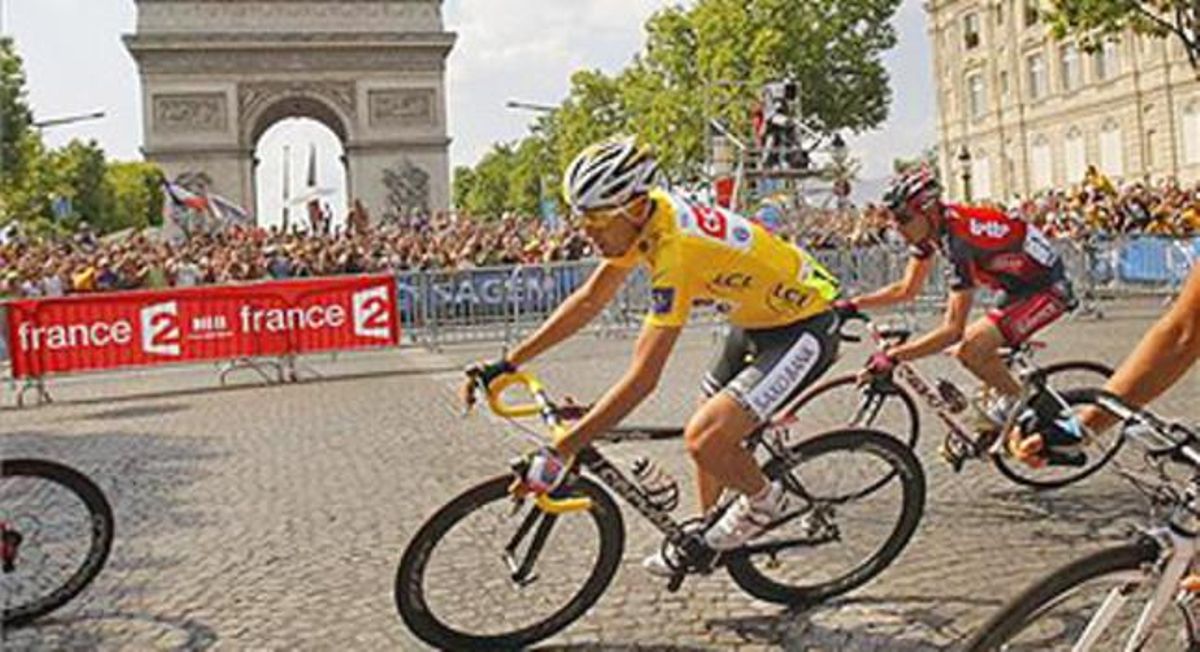 Sastre passa amb el seu mallot groc davant de l’Arc de Triomf de París.
