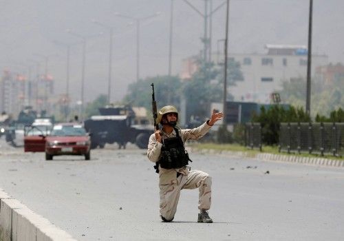 Member of Afghan security forces shouts orders at the site of an attack near the Afghan parliament in Kabul, Afghanistan