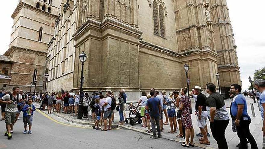 Un grupo de turistas haciendo cola para visitar la Catedral de Palma.