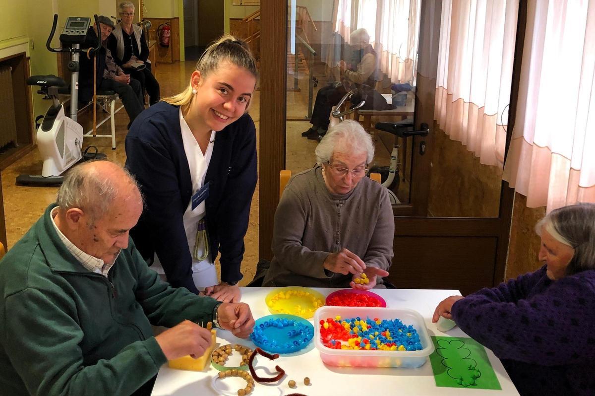 Paula Aumente, fisioterapeuta del centro, junto con algunos residentes