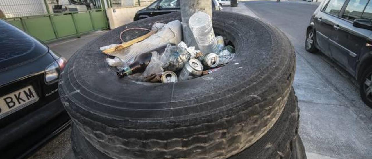 Unos neumáticos colocados para evitar accidentes en uno de los postes por la falta de zona de estacionamiento en el polígono.