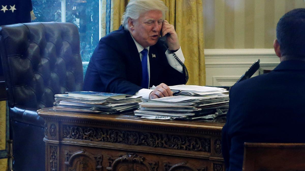 Trump speaks by phone with Merkel in the Oval Office at the White House in Washington