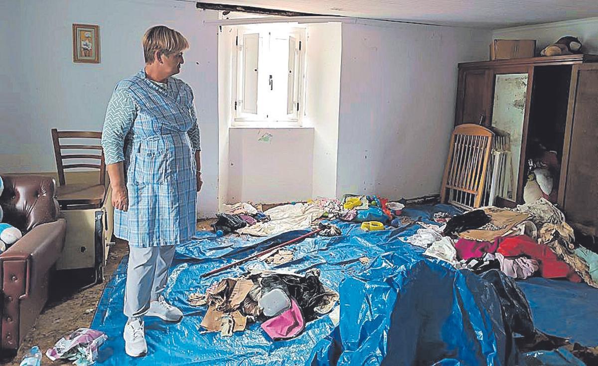 La propietaria de la casa en una estancia llena de basura.