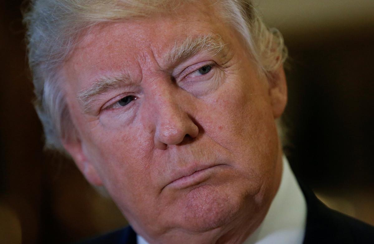 FILE PHOTO: U.S. President-elect Donald Trump listens to questions from reporters in the lobby at Trump Tower in New York, U.S., January 9, 2017.   REUTERS/Mike Segar/File Photo