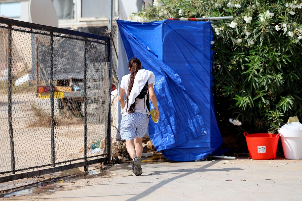 Una mujer se dirige a la 'ducha' situada en el exterior de Can Rova.