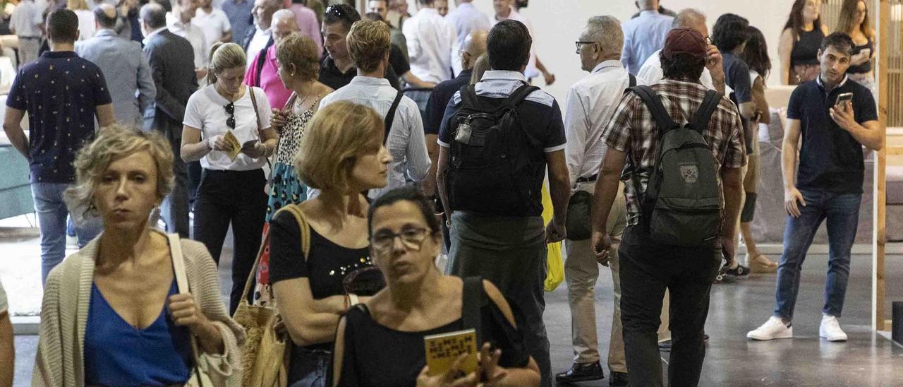 Visitantes caminando por uno de los pabellones de Feria Hábitat València, ayer.