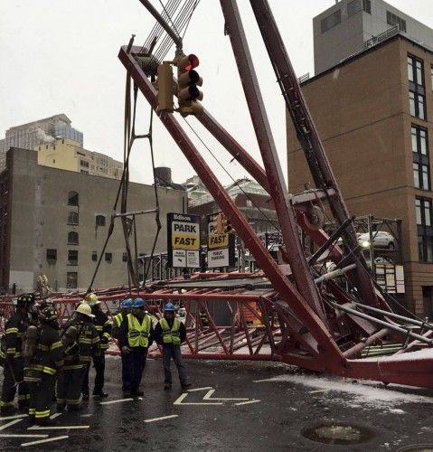 Emergency crews survey a massive construction crane collapse on a street in downtown Manhattan in New York