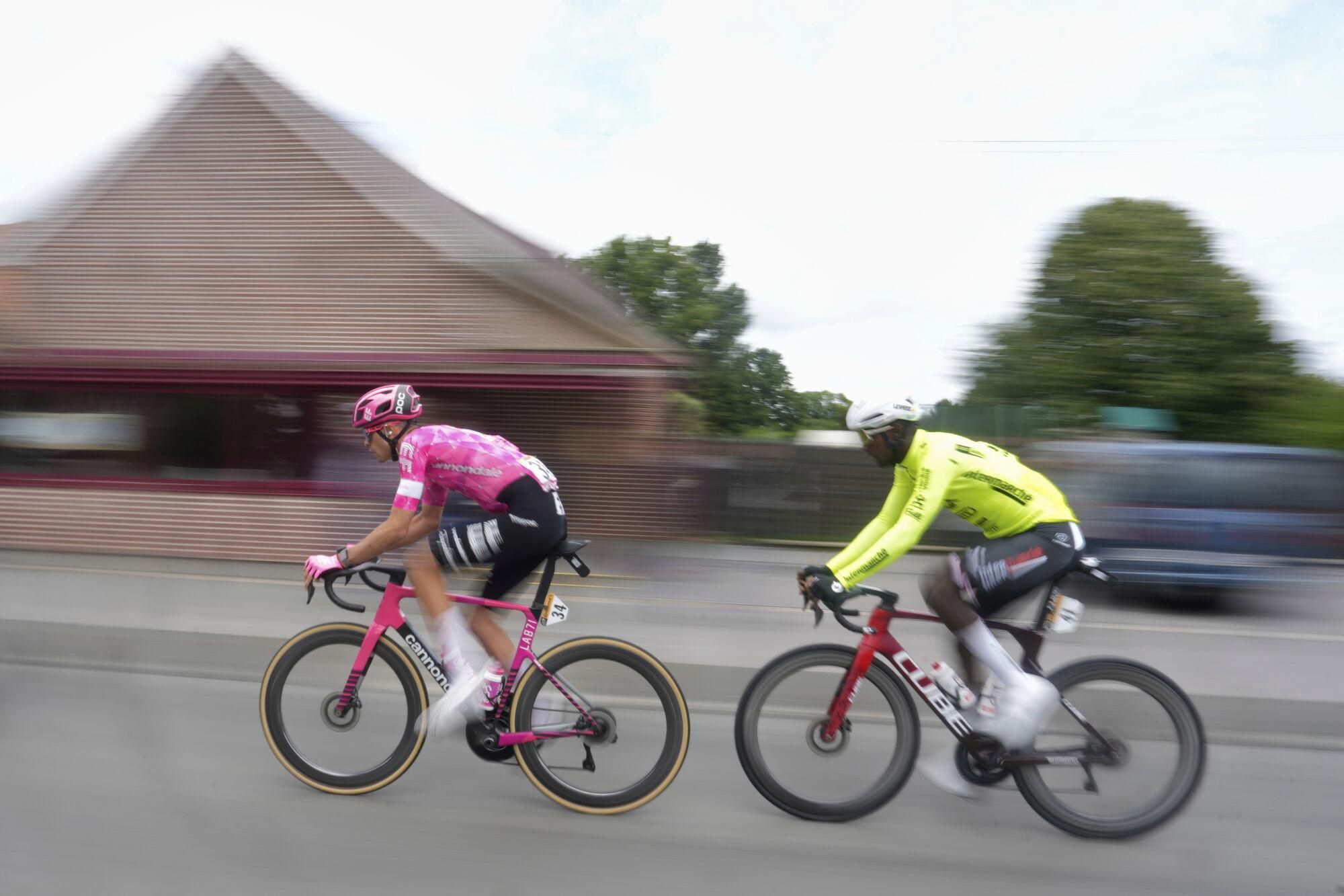 France's Alex Baudin, left, and Eritrea's Biniam Girmay ride during the third stage of the Tour de France cycling race over 178.3 kilometers (110.8 miles) with start in Valenciennes and finish in Dunkerque, France, Monday, July 7, 2025. (AP Photo/Mosa'ab Elshamy)