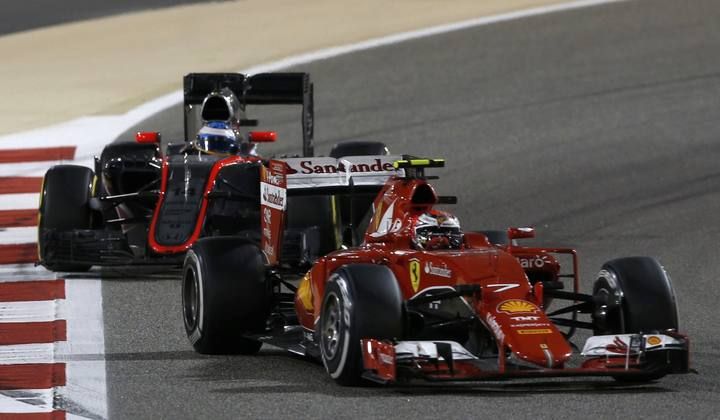 Ferrari driver Raikkonen of Finland drives ahead of McLaren driver Alonso of Spain during Bahrain's F1 Grand Prix