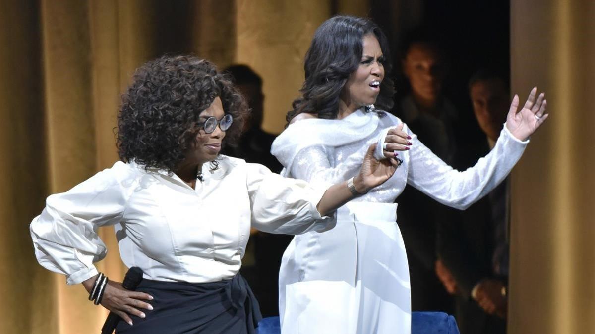 lmmarco45888821 michelle obama  right  is greeted by oprah winfrey to discus190328132511