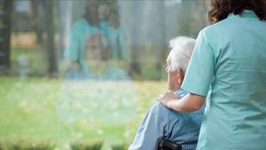 undefined42762920 young caring nurse cheering up the sick patient  alzheimer  200218173656