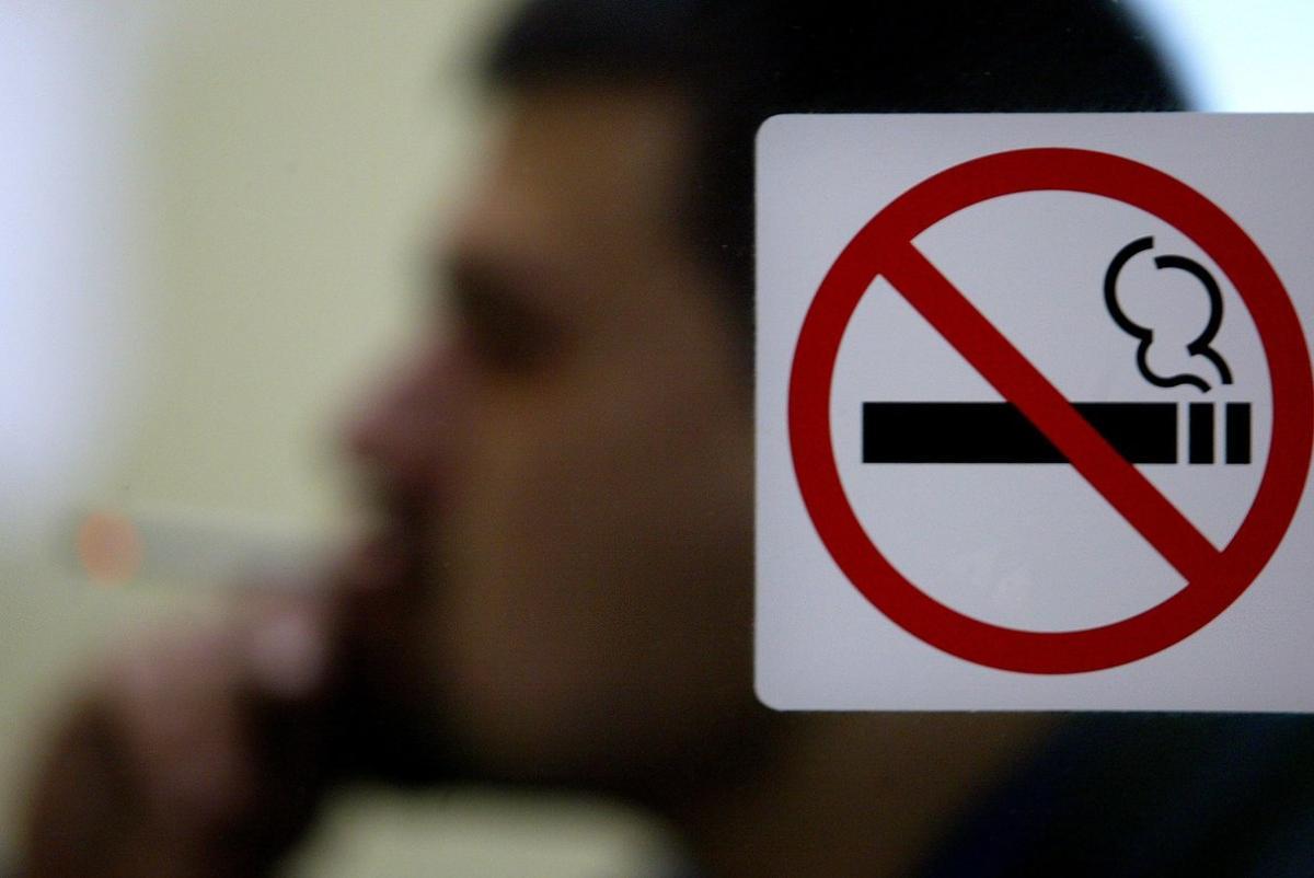 A Bulgarian man smokes cigarette in a cafe in central Sofia, January 16, 2005. Smoking is now forbidden in hospitals, schools, museums, day care centres and theatres. The Bulgarian government is giving the normally smoke-choked bars and bistros until June to introduce no-smoking tables and install costly ventilation-requirements that have angered restaurateurs. Picture taken January 16.  TO ACCOMPANY FEATURE BC-BULGARIA-SMOKING       REUTERS/Stoyan Nenov