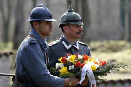 A French and a German member of World War One historical associations lay a wreath for soldiers from both sides who were killed near the wiped-out village of Bezonvaux, near Verdun, eastern France