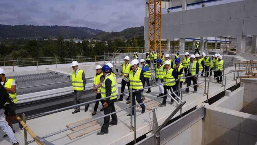 La comitiva de técnicos y políticos ayer durante la visita a las obras de la EDAR de Reza. // Jesús Regal