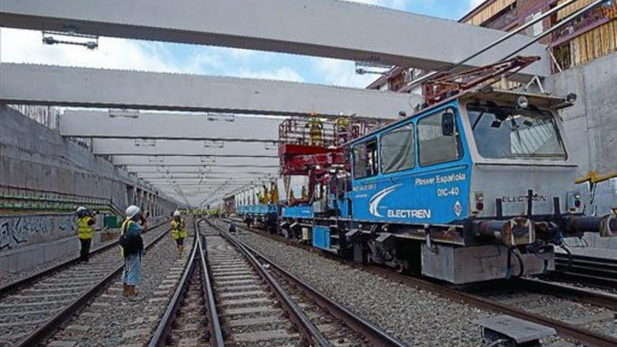 Trabajos de construcción del cajón que cubrirá las vías de ancho convencional en Sants, ayer.