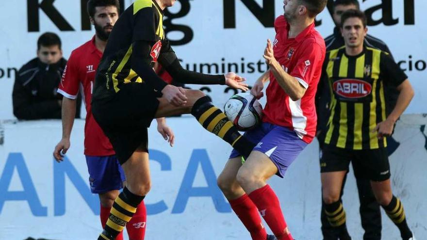 Iago Paz, del Rápido de Bouzas, trata de despejar el balón durante el encuentro de ayer tarde ante el Choco. // FDV