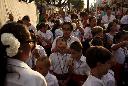 People in traditional costumes take part in the procession of the El Carmen Virgin being carried into the sea in Malaga