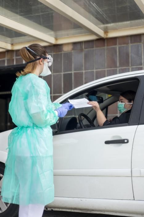 Una enfermera del CHUO realiza una prueba a una mujer en la zona habilitada para el test del coronavirus. // Carlos Peteiro