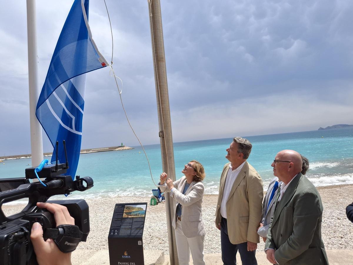 La alcaldesa de Xàbia iza la bandera azul de la playa de la Grava