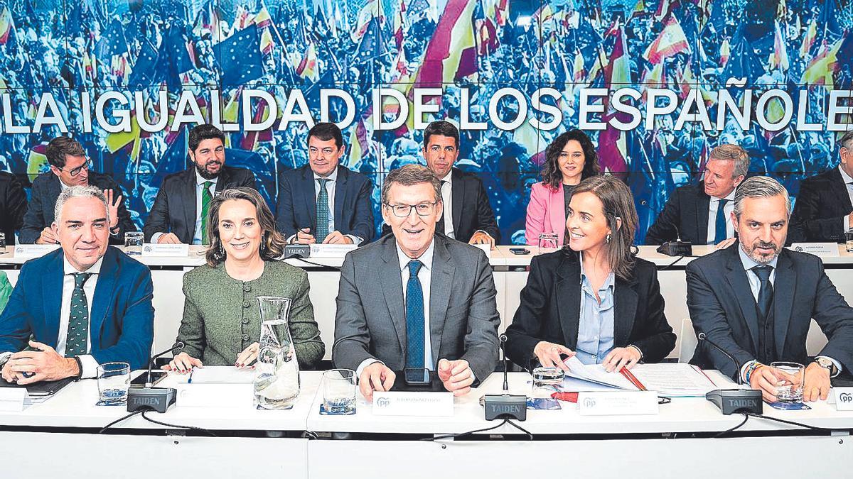 Carlos Mazón, tras Alberto Núñez Feijóo y junto a otros líderes del Partido Popular, en la Junta Directiva de la formación política que se celebró en la jornada de ayer en Madrid.